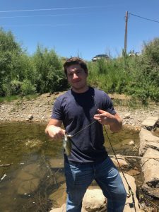 Hugh fishing with family, he says he always catches the smallest fish! (Photo courtesy of Hugh Turner)